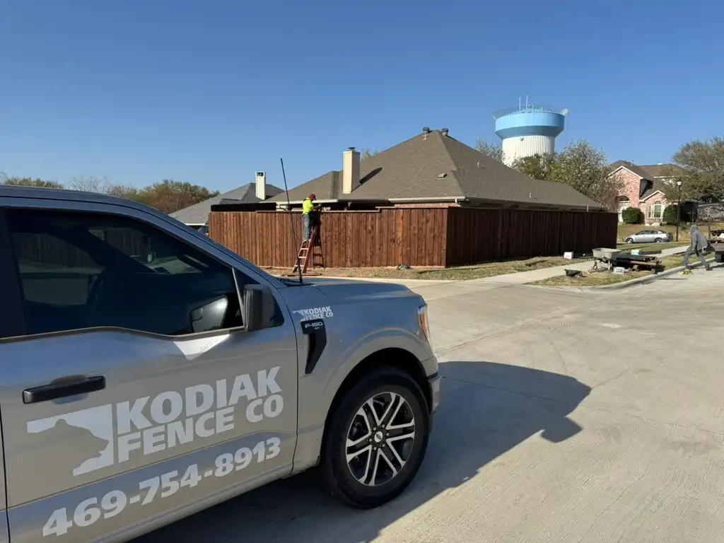Kodiak Fence Company crew and truck installing a wood fence